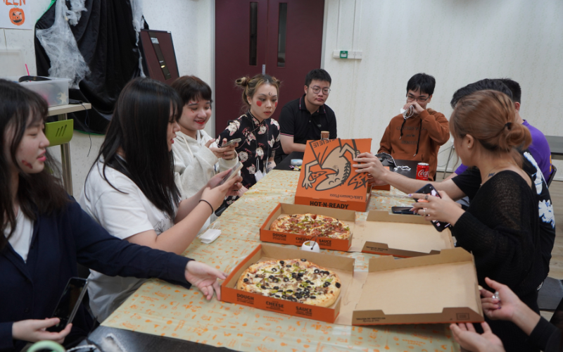SLE students having pizza in their classroom.